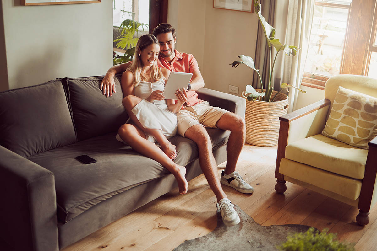 We have a connection stronger than wifi. Shot of a young couple using a digital tablet together at home. couple looking at a tablet