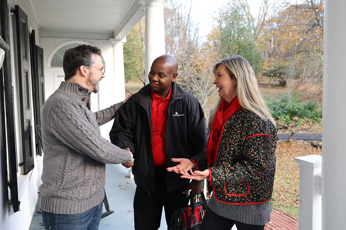 Guide to Winterizing Your HVAC System for a Colorado Winter 2 Homeowner shaking a HomeServe techs hand on the porch